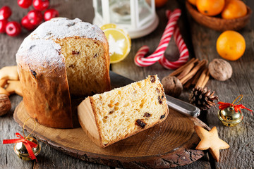Traditional Italian Christmas fruit cake Panettone  with Christmas decorations, gift box and mulled...
