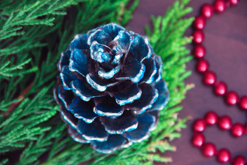 New Year's colorful cones and branches of a green Christmas tree with decor in the form of red beads