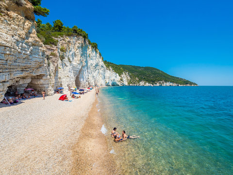 APULIA, IT - Jul 19, 2018: Mattinata Faraglioni stacks and beach coast of Baia Delle Zagare, Vieste Gargano, Apulia, Italy