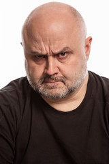 Bald man with angry facial expression, close-up