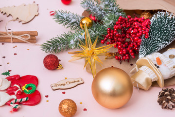 Fototapeta na wymiar spruce branch, Golden red Christmas balls, snowman, red berries, cinnamon sticks, happy Christmas inscription