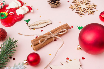Golden red Christmas balls, cinnamon sticks, merry Christmas inscription, snowflake