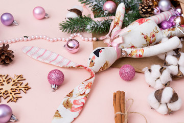 spruce branch,  branch of the cotton, rabbit poured out of the envelope, pink and silver Christmas ball with snowflake,  cone, still life in pink