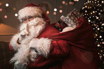 Santa Claus with finger on the lips gesturing shh sign  - Powered by Adobe