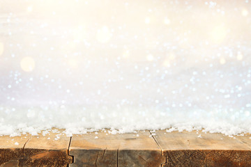 Image of old wooden table in front of glitter lights background. De-focused. Ready for product display montage.