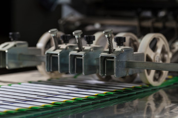 Folding machine industrial. Demonstration of the workflow. Equipment for color printing.