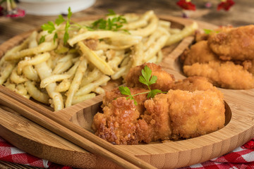 Chicken nuggets with yellow beans.
