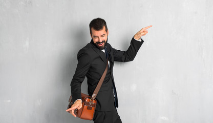Fototapeta na wymiar Businessman with beard enjoy dancing while listening to music at a party
