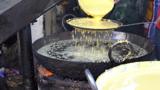 Street trade food : cooking chiape rayta on the street market in city Udaipur, Rajasthan, India. Indian chef making street food. Close up