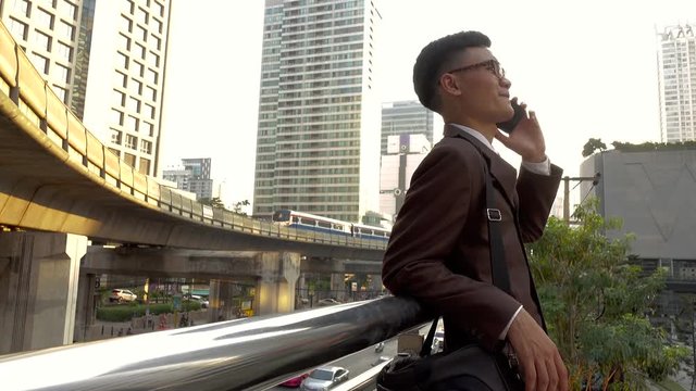 Business man using smart phone in modern city