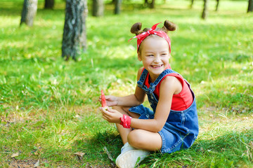 Obraz na płótnie Canvas happy little girl in red T-shirt