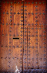 Wooden door in toledo with old nails Spain