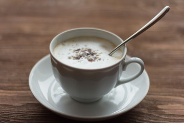 white latte coffee Cup on wooden background