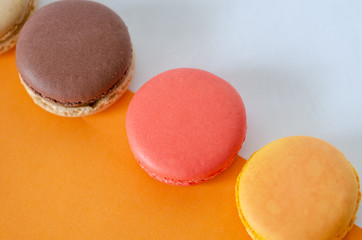 French macarons are on the orange-white background.