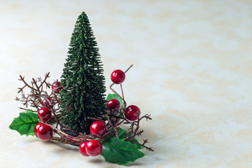 Holiday composition with christmas tree and wreath with holly berries, on white beige background,...