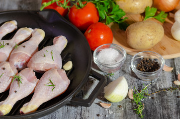 Raw chicken legs  in the pan- ready for cooking