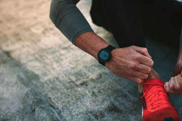 Top view of a man tying shoe lace