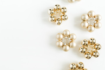 Christmas composition with golden decoration balls on white background. Flat lay, top view. Blog hero header.