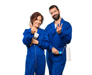 Painters happy and counting three with fingers on isolated white background