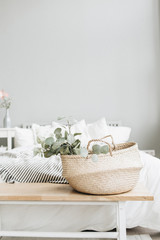 Modern scandinavian apartment interior design. Bed and eucalyptus branch.