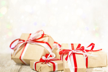 Christmas gift box against bokeh background. Holiday greeting card decorated with snow