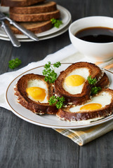 Baked toasts with egg filling and fresh parsley on a plate    