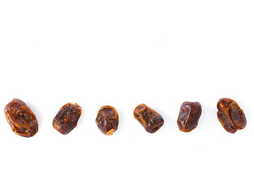 Dried halawi dates on a white