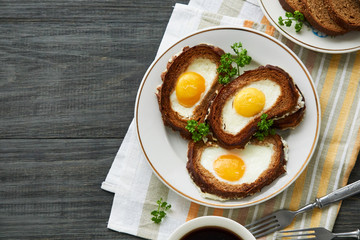 Baked toasts with egg filling and fresh parsley on a plate    