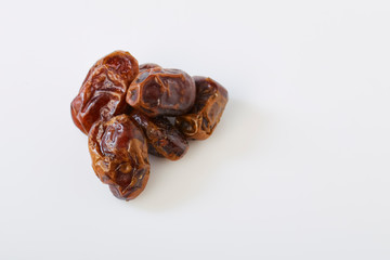 Dried halawi dates on a white