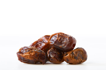 Dried halawi dates on a white