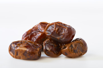 Dried halawi dates on a white