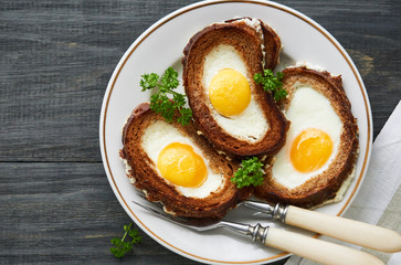 Baked toasts with egg filling and fresh parsley on a plate    