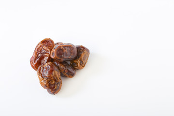 Dried halawi dates on a white