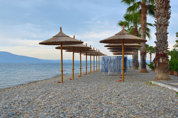 beach umbrellas made of bamboo on the banks of the sea