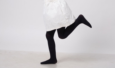 model in black tights in white studio