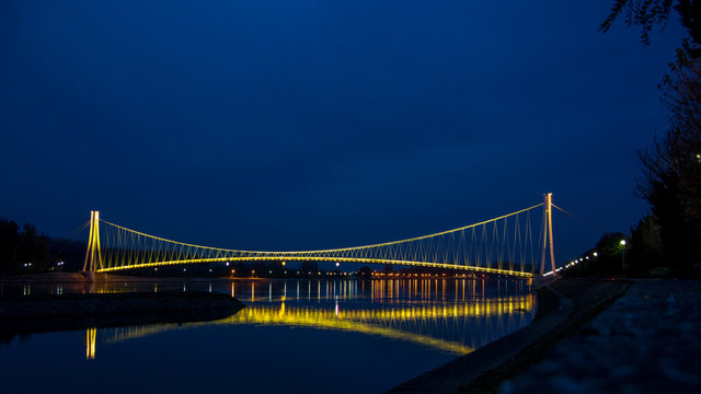 Side view of a colorful modern pedestrian bridge. Night in Osijek, Croatia.