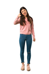 A full-length shot of a Teenager girl with pink shirt frustrated by a bad situation and pointing to the front