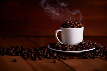 A white cup full of hot coffee beans on a wooden table