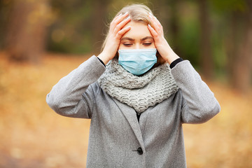 Cold and flu. Woman with a medical face mask at outdoor