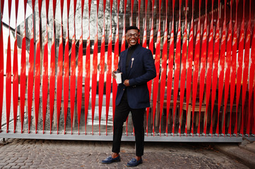 Amazingly looking african american man wear at blue blazer with brooch, black turtleneck and...