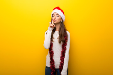 Teenager girl celebrating christmas holidays showing a sign of closing mouth and silence gesture