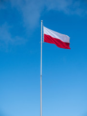 Fototapeta na wymiar flag of poland in the wind against a sky