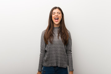 Teenager girl on isolated white backgorund shouting to the front with mouth wide open