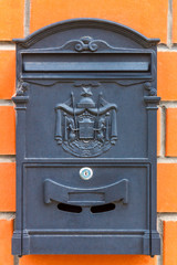 A beautiful mailbox hangs waiting for newspapers, parcels and letters.