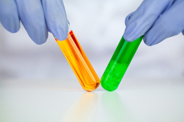 Biological test. Woman holding flask in lab. The scientist,dermatologist testing the organic...