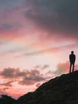 silhouette of man on top of mountain