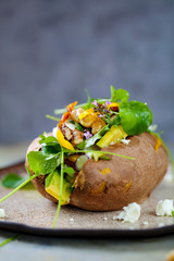 Baked sweet potato with salad