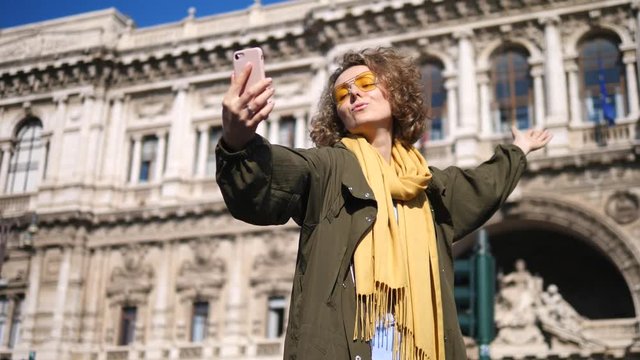 Young Woman Taking Selfie With Cell Phone Traveling In Europe. Trip To Europe.