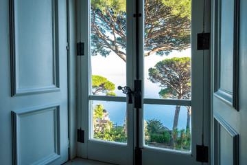 Window view from luxury villa Rufolo on garden at Mediterranean sea, Ravello.