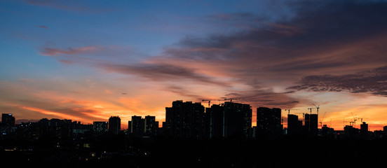 Colourful sunset sky over city with skyscrapers